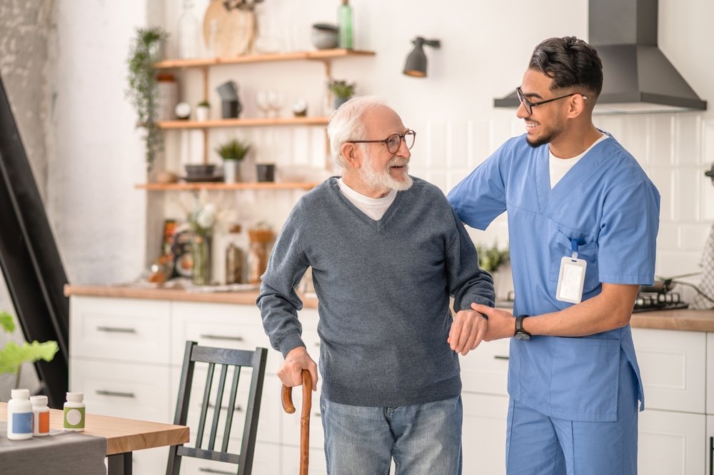 Medical,Worker,Helping,His,Patient,To,Move,Around,The,Apartment